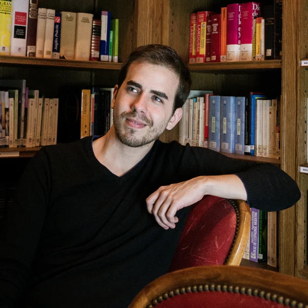 Antonio Torres Olmo sat in a room full of books.