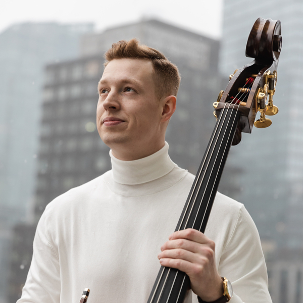Brock Drevlow holding a double bass.