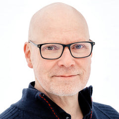 bald man with glasses, on a white backgournd.