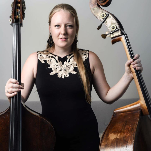 Phoebe Russell holding two basses