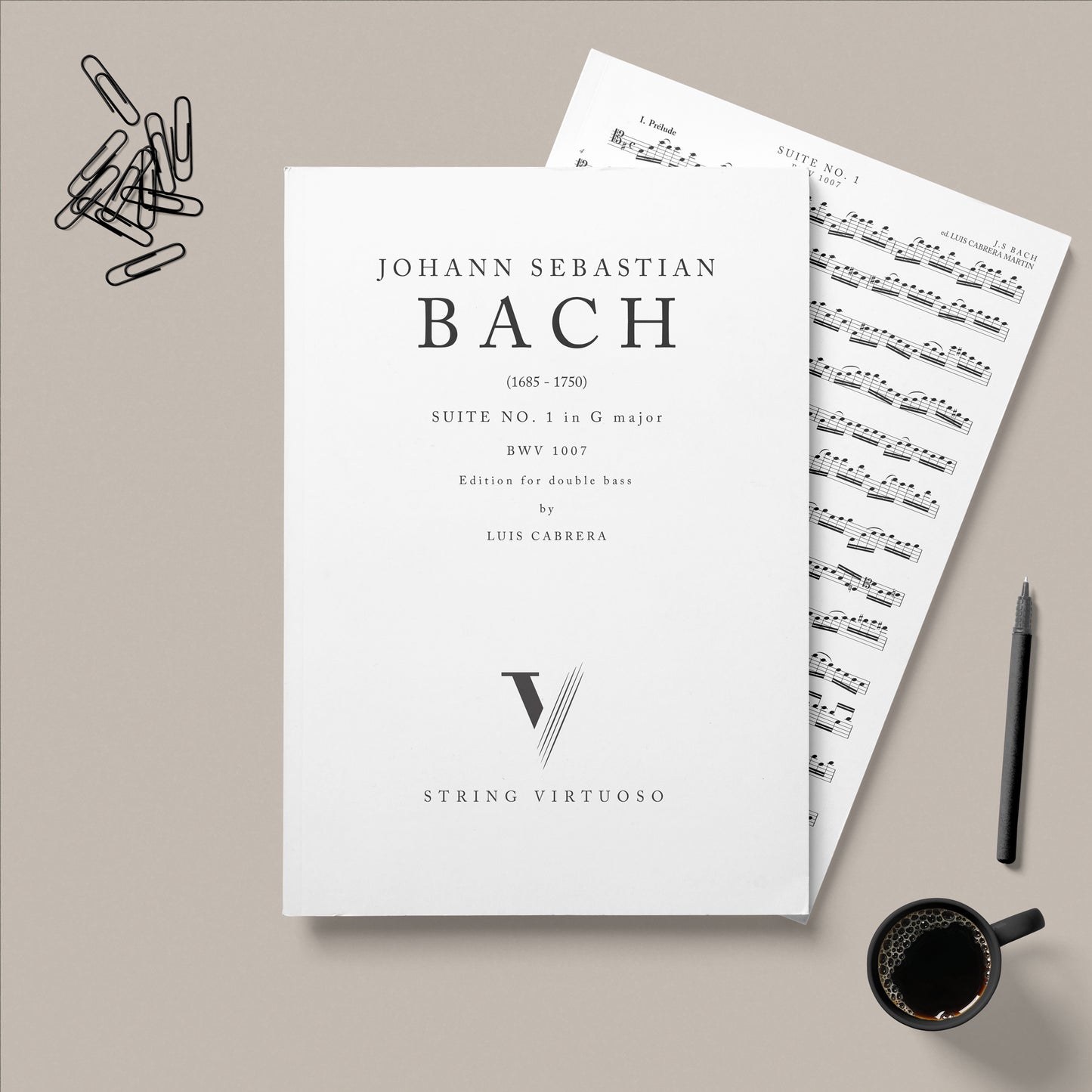 PDF Sheet music by Bach JS, Suite No.1 in G major for double bass edition Luis Cabrera Martin. Laid on a beige background with paper clips, a pen and a cup of coffee.