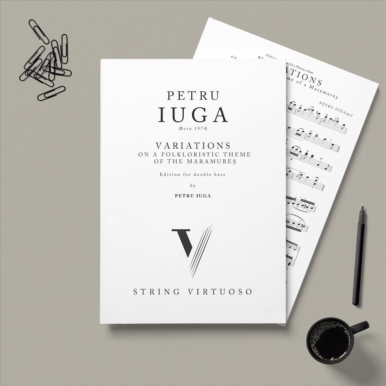 Sheet music by Petru Iuga, Variations on a Folkloristic Theme of the Maramures, edition for double bass on a grey background with a pen and coffee cup.