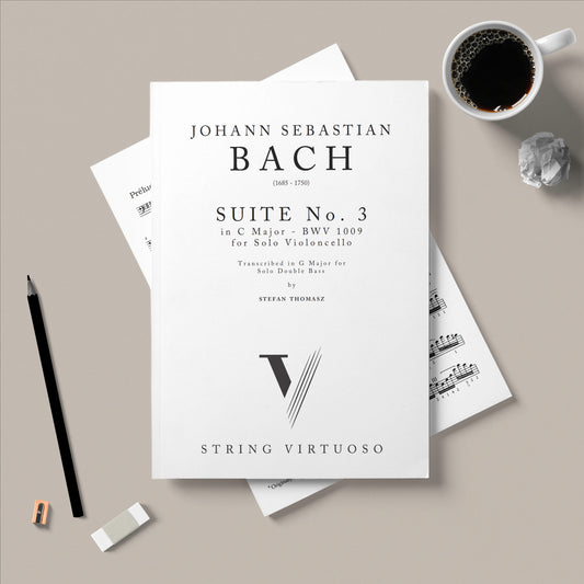 Sheet music for Johann Sebastian Bach's Suite No. 1 on a gray surface with a cup of coffee and pencil.