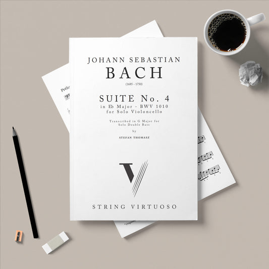 Sheet music for Johann Sebastian Bach's Suite No. 4 on a gray surface with a cup of coffee and pencil.