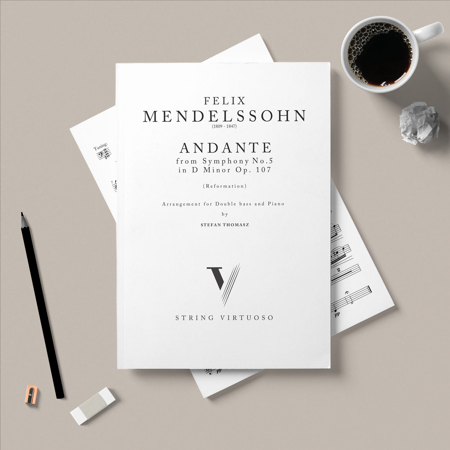 Sheet music for Felix Mendelssohn's Andante arranged for double bass and piano by Stefan Thomasz on a beige surface with a cup of coffee and pencil.