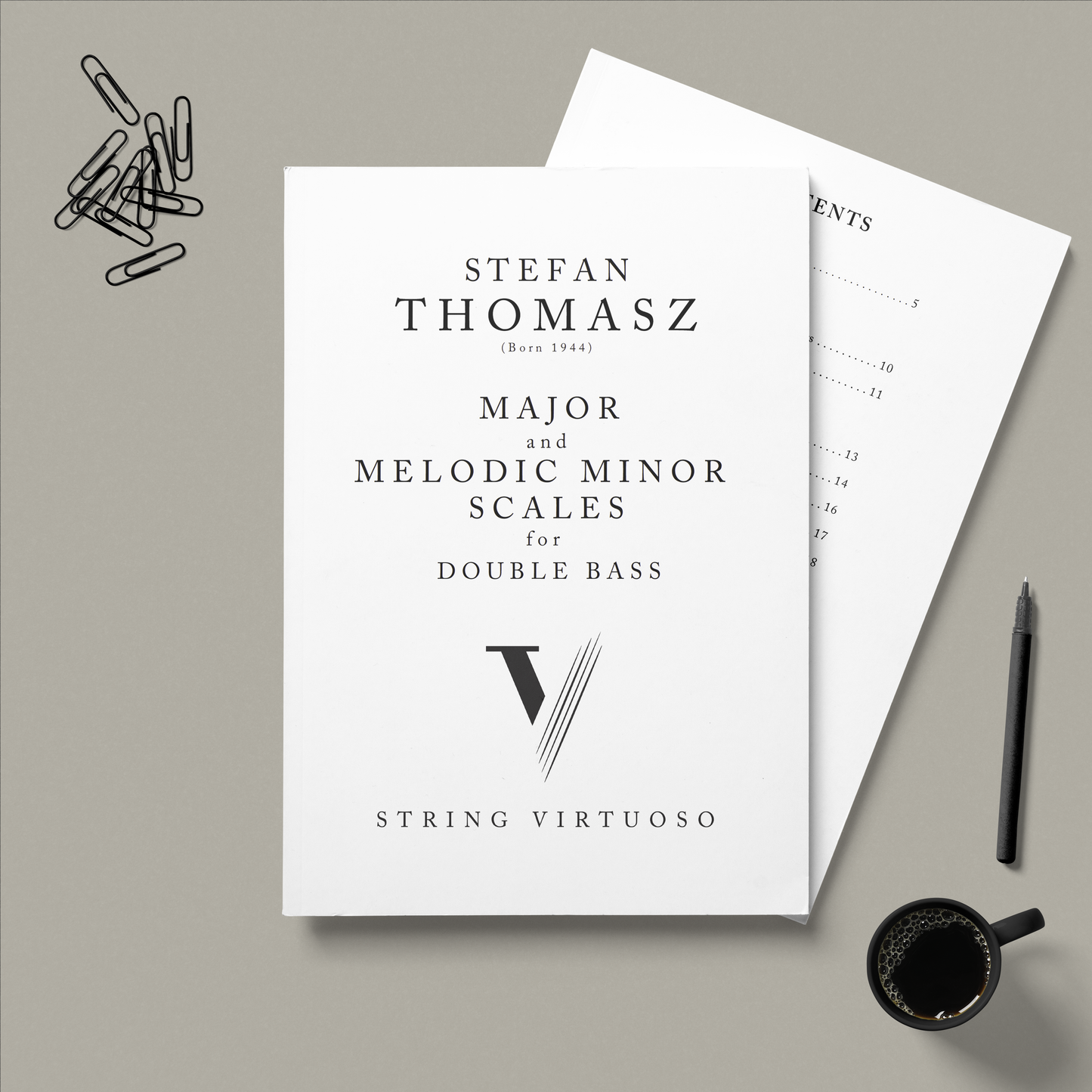 Sheet music titled 'Major and Melodic Minor Scales for Double Bass' by Stefan Thomasz on a grey background with a pen and coffee cup.