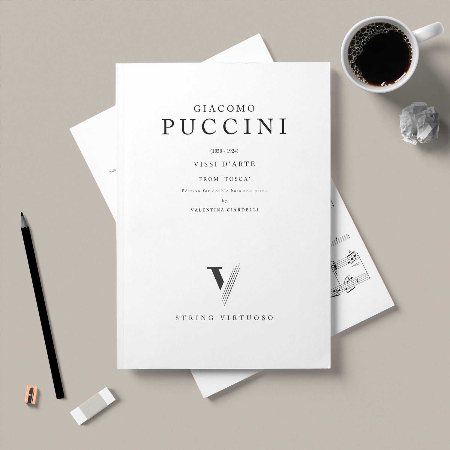 A digital sheet music cover for 'Giacomo Puccini - Vissi D'arte' from the opera Tosca, displayed on a table with a cup of coffee and pencils.