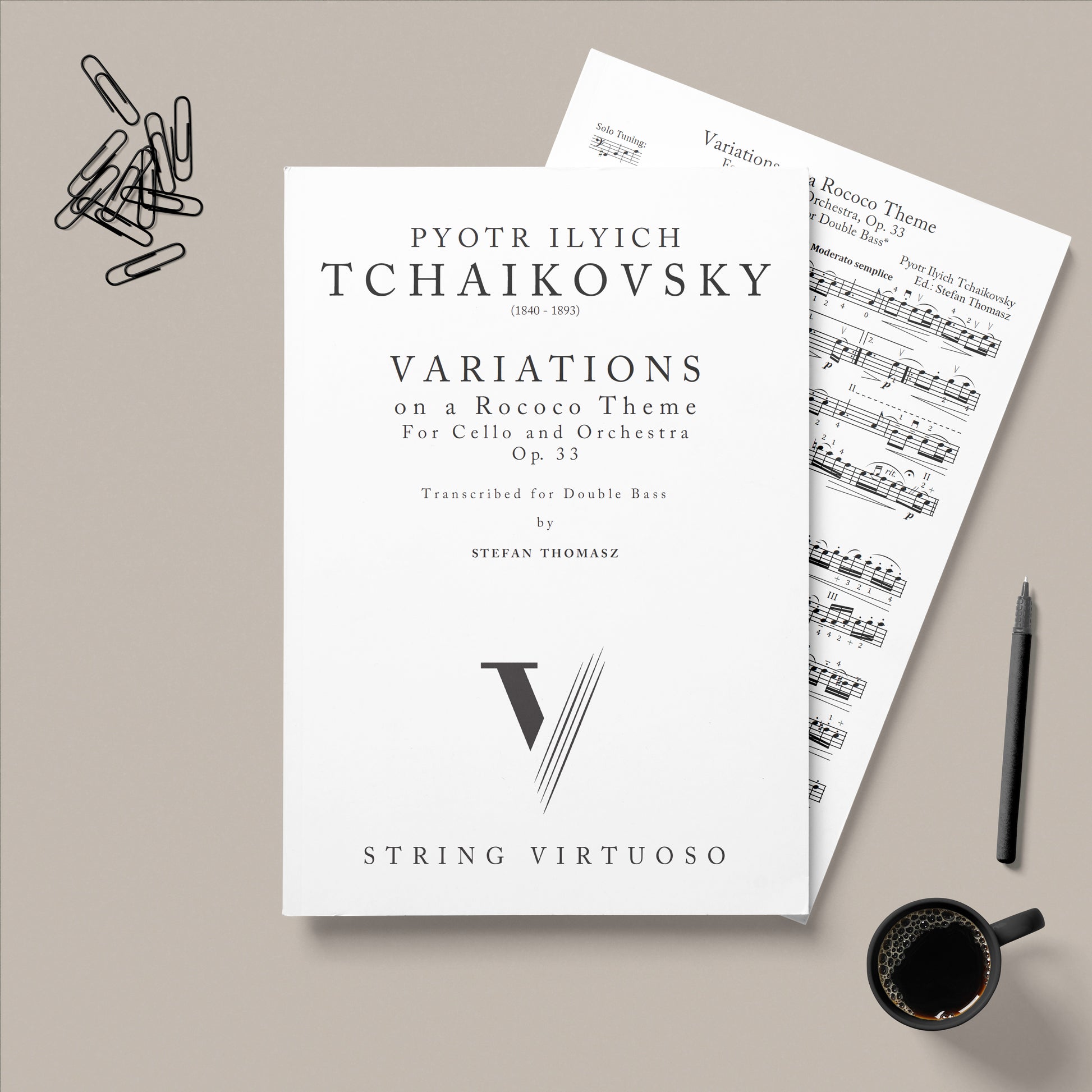 Sheet music for Tchaikovsky's Variations on a Rococo Theme with a pen and coffee cup on a gray background